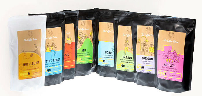 A photo of the 8 different speciality coffee bags that The Coffee Twins offer.  Hufflelump, Little Robot, Jojo, Ant, Bobo, Parrot, Komodo and Audley