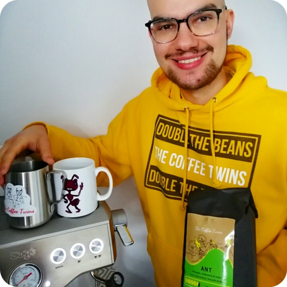 the coffee twins founder by the espresso machine and the bag of our Ant Coffee Bag