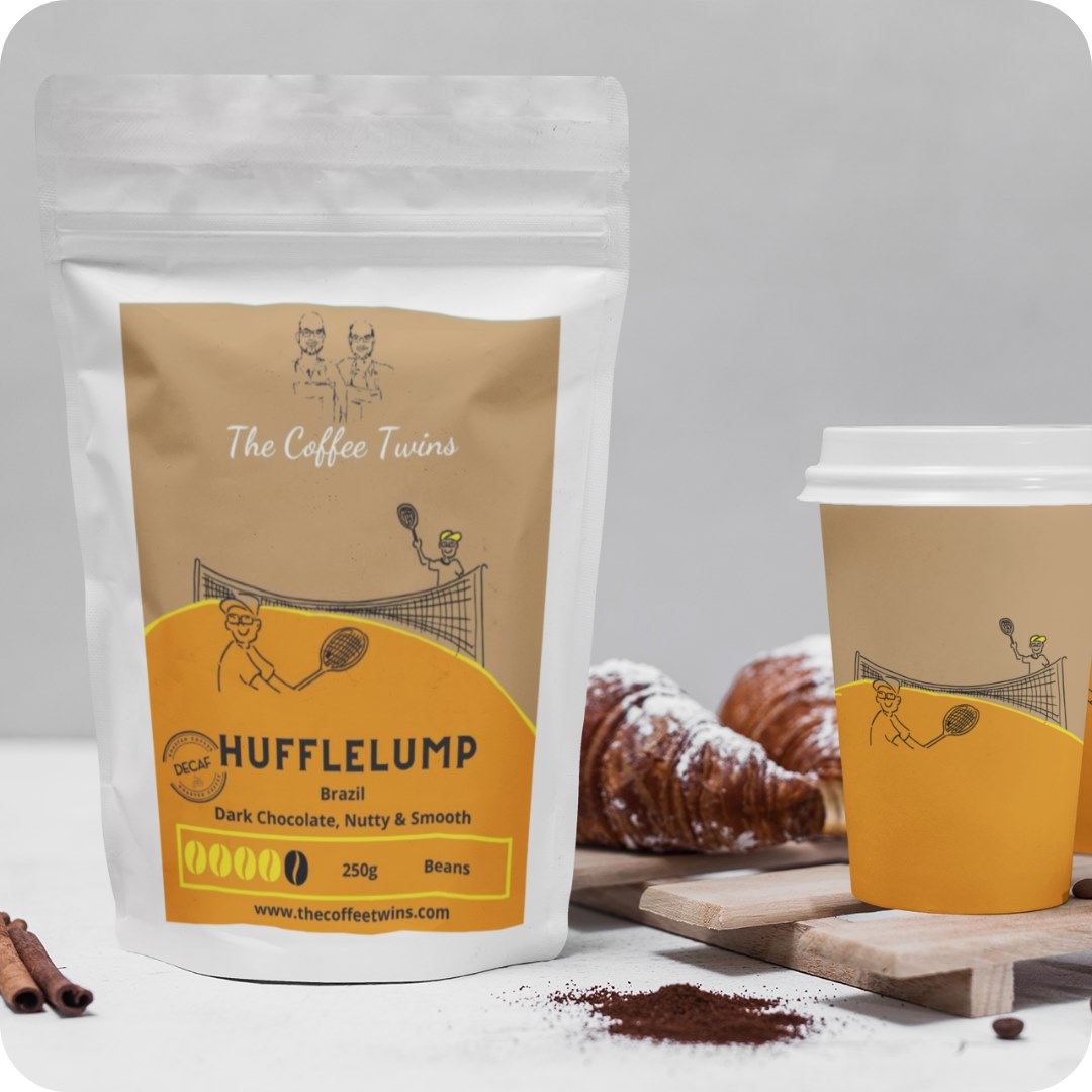 Hufflelump coffee bag from The Coffee Twins alongside a coffee cup and croissant.
