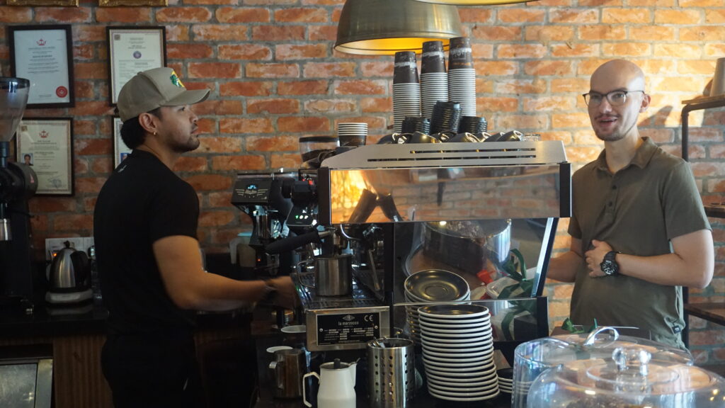 roasted sip, rr behing the espresso machine 