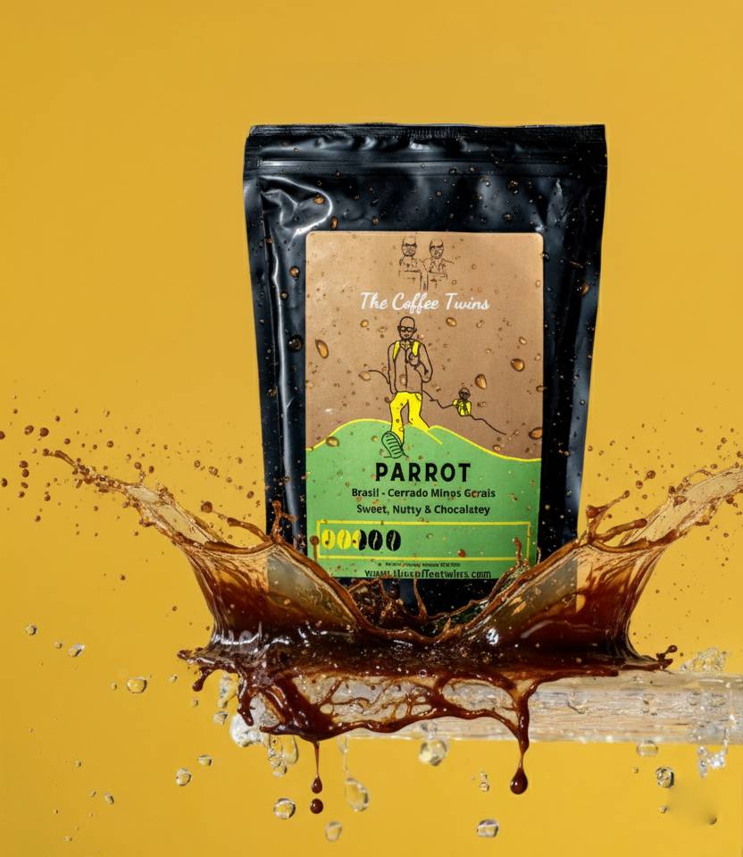 Coffee bag labeled 'Parrot' from The Coffee Twins with a splash of coffee around it.