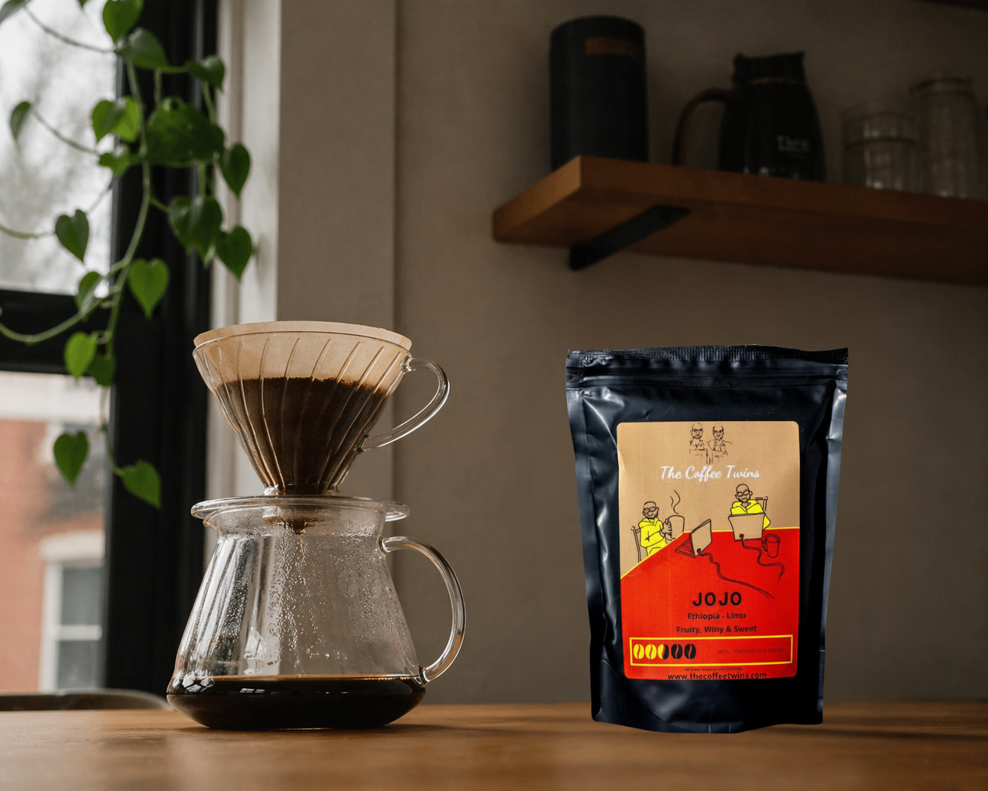 Glass v60 kit on a table with a bag of Jojo coffee