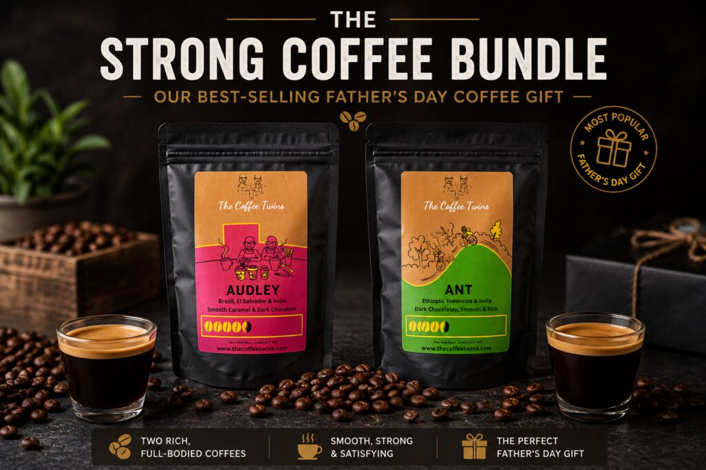 The Strong Coffee Bundle from The Coffee Twins featuring Audley and Ant speciality coffee bags displayed side-by-side on a dark coffee-themed background. Two espresso cups, scattered roasted coffee beans, and Father's Day gift styling highlight the bundle as a popular coffee gift for dads. Audley offers smooth caramel and dark chocolate notes, while Ant delivers rich dark chocolate flavours with a smooth, full-bodied finish.