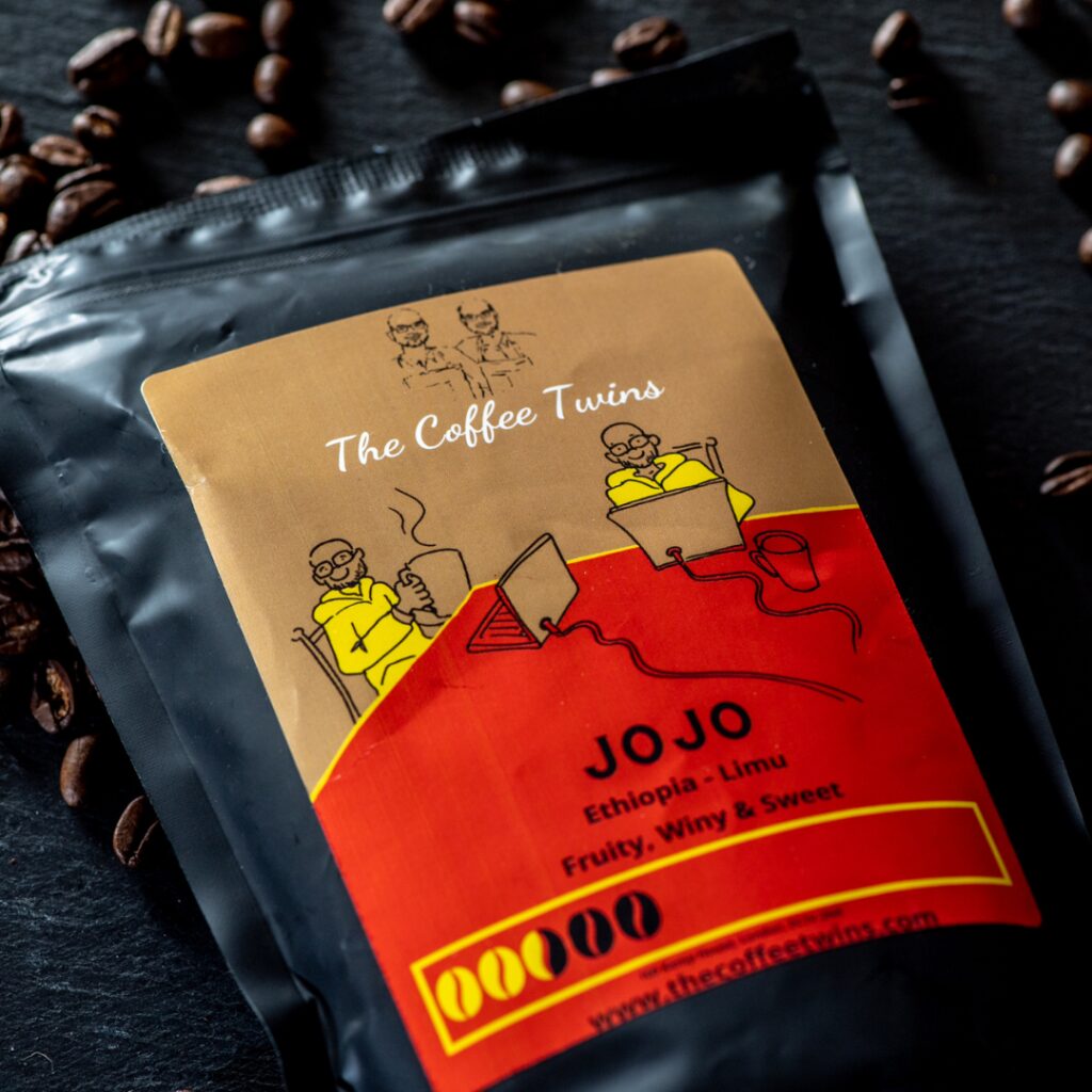 The Coffee Twins Jojo speciality coffee blend photographed with an espresso shot and roasted coffee beans.