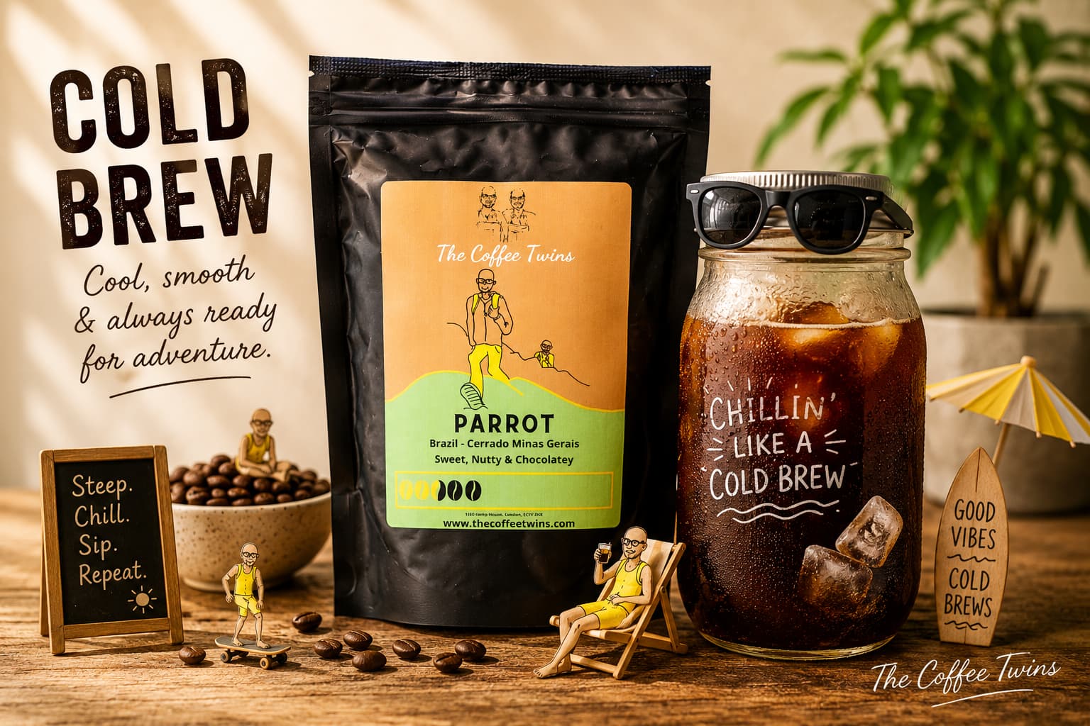 Fun cold brew coffee scene featuring The Coffee Twins Parrot coffee bag beside a mason jar of iced cold brew with ice, playful summer props, coffee beans and bold “Cold Brew” text on a rustic wooden table, with a subtle The Coffee Twins watermark in the bottom-right corner.