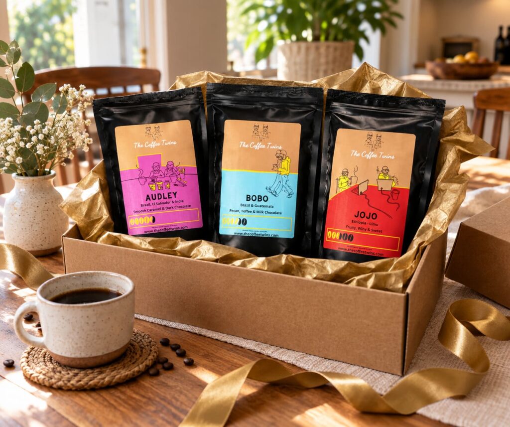 The Coffee Twins Audley, Bobo and Jojo coffee gift box with gold tissue paper, gold ribbon and ceramic coffee cup.