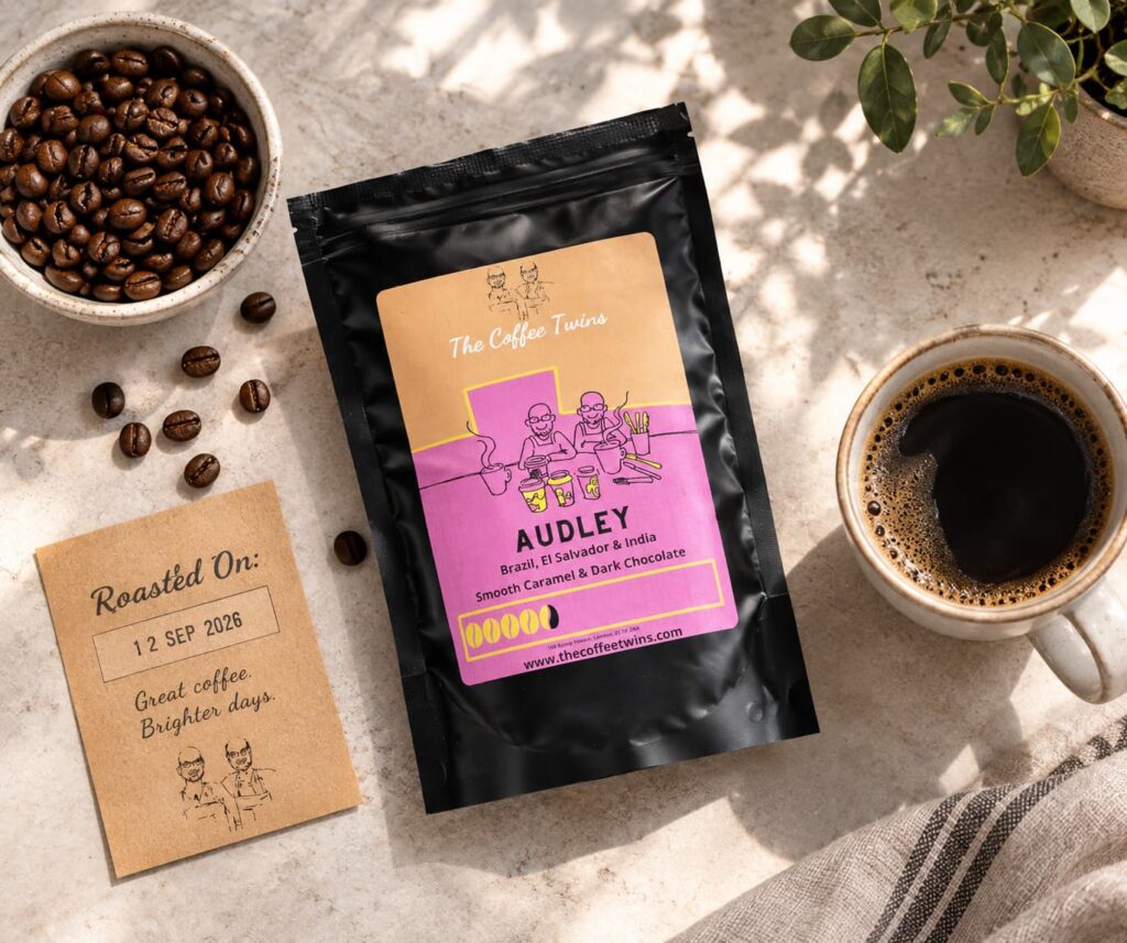 The Coffee Twins Audley coffee bag with fresh coffee beans, roast date card and freshly brewed black coffee.