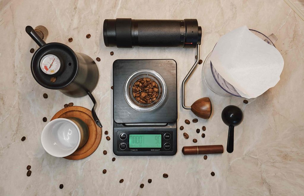 An attractive overhead photograph divided visually into four sections:
- Fresh coffee beans
- Correct grind size
- Coffee-to-water ratio
- Water temperature